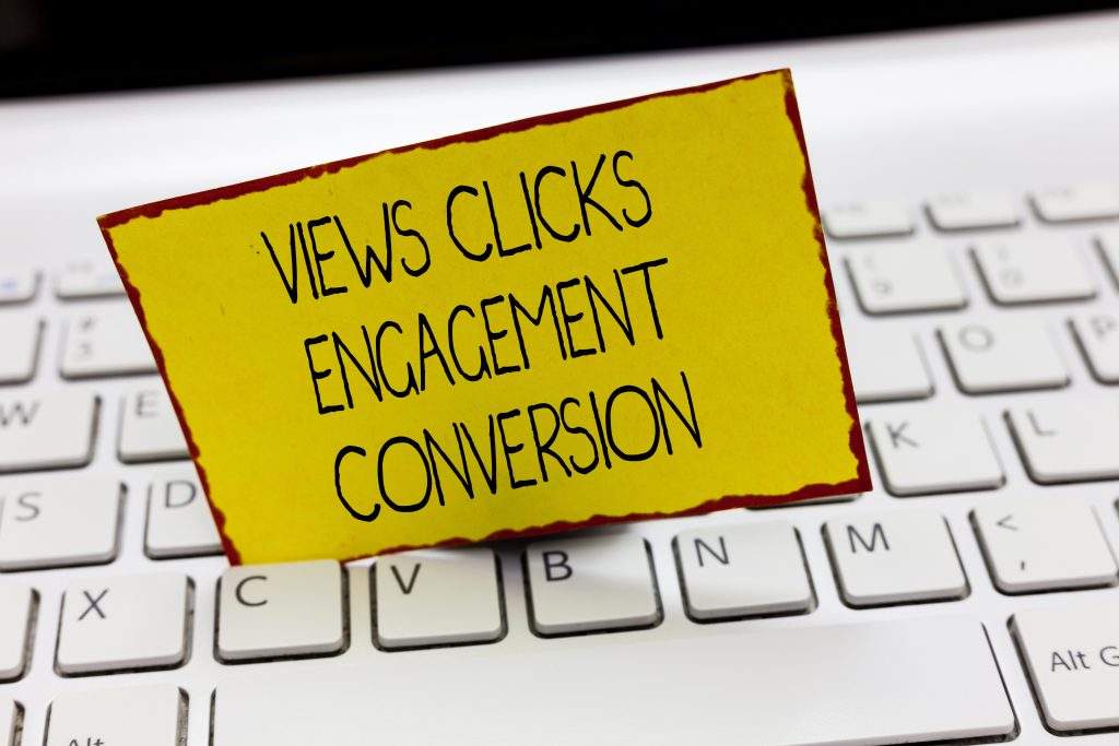 Views, clicks, engagement, conversion written on paper.