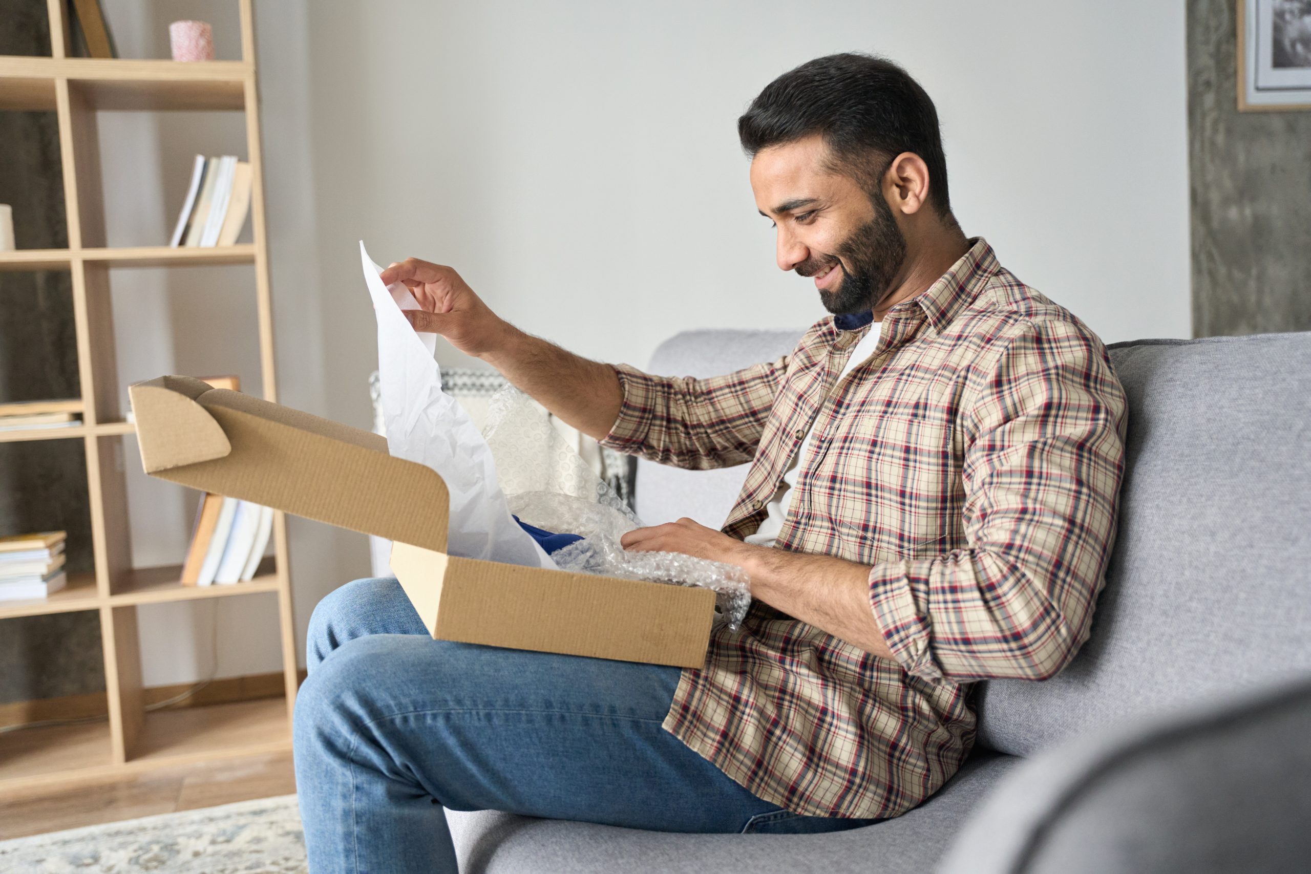 Male customer opening online shop parcel