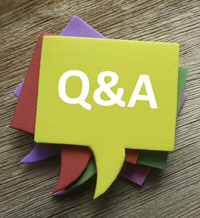 stack of colorful comment bubble notes with Q&A on top of wooden table